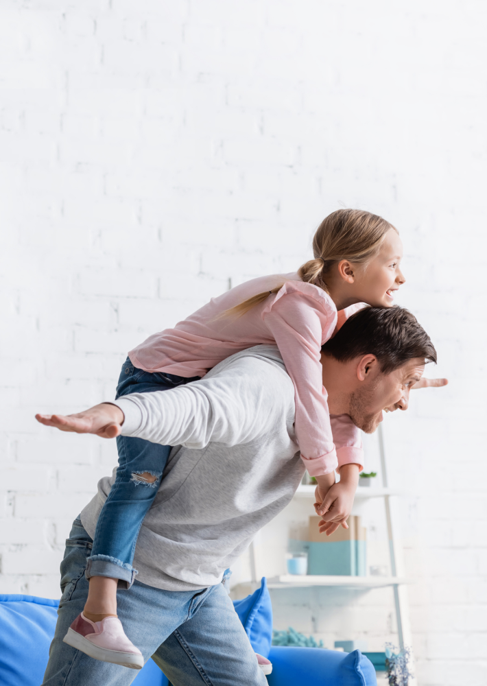 Hombre con su hija juando al avión.